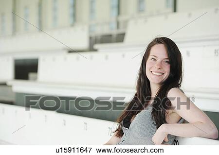 Stock Photo - Smiling woman sitting on bench. Fotosearch