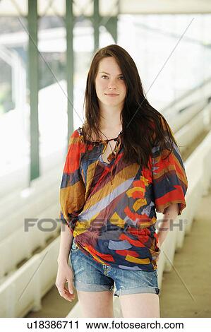 Smiling woman standing on bleachers View Large Photo Image Stock Image - Smiling woman standing on bleachers. Fotosearch