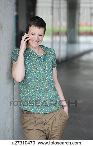 Smiling woman talking on cell phone View Large Photo Image Stock Image - Smiling woman talking on cell phone. Fotosearch