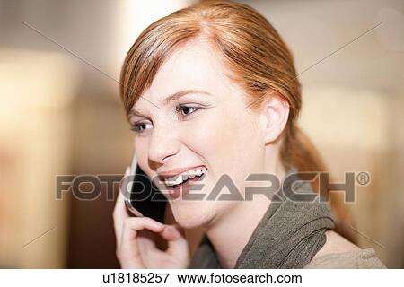 Smiling woman talking on cell phone View Large Photo Image Stock Photo - Smiling woman talking on cell phone. Fotosearch