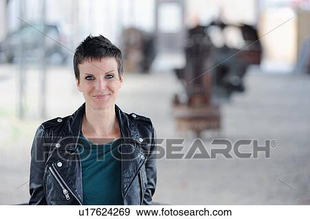 Stock Photo - Smiling woman walking on city street. Fotosearch