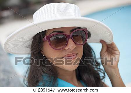Smiling woman wearing sunhat outdoors View Large Photo Image Stock Photo - Smiling woman wearing sunhat outdoors. Fotosearch