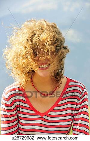 Smiling woman’s hair blowing in wind View Large Photo Image Stock Image - Smiling woman’s hair blowing in wind. Fotosearch