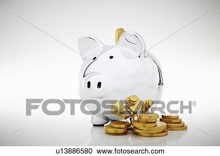 Stock Image - Stack of gold coins by piggy bank. Fotosearch