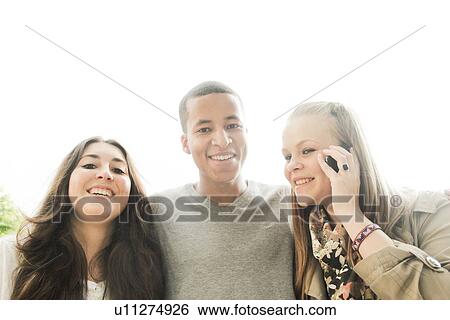 Teenagers standing together outdoors View Large Photo Image Stock Photograph - Teenagers standing together outdoors. Fotosearch