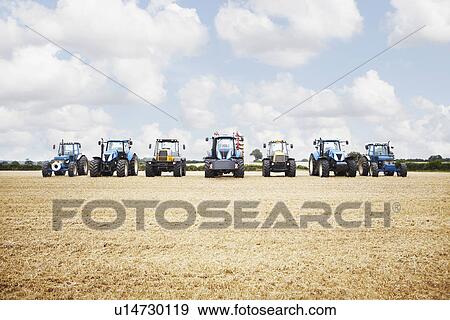 Tractor harvesting grains in crop field View Large Photo Image Stock Photo - Tractor harvesting grains in crop field. Fotosearch