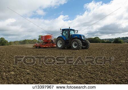 Tractor working in crop field View Large Photo Image Stock Photo - Tractor working in crop field. Fotosearch
