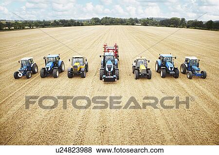 Stock Photo - Tractors parked in tilled crop field. Fotosearch