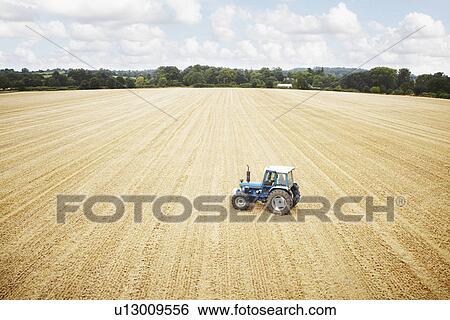 Tractors parked in tilled crop field View Large Photo Image Stock Photograph - Tractors parked in tilled crop field. Fotosearch