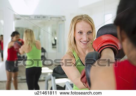 Trainer working with boxer in gym View Large Photo Image Stock Image - Trainer working with boxer in gym. Fotosearch