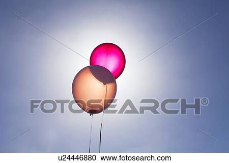 Stock Image - Translucent balloons against blue sky. Fotosearch