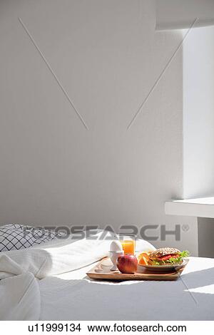Tray of breakfast food on bed View Large Photo Image Picture - Tray of breakfast food on bed. Fotosearch