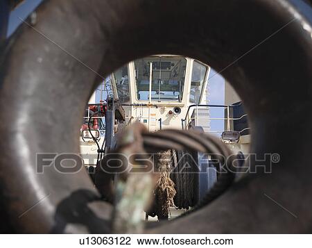 Stock Image - Tugboat bridge through tow line guide. Fotosearch