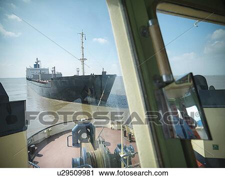 Tugboat pulling ship in ocean View Large Photo Image Stock Image - Tugboat pulling ship in ocean. Fotosearch