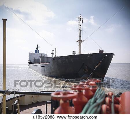 Tugboat pulling ship in ocean View Large Photo Image Stock Photo - Tugboat pulling ship in ocean. Fotosearch