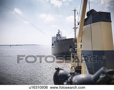 Tugboat pulling ship in ocean View Large Photo Image Stock Photograph - Tugboat pulling ship in ocean. Fotosearch
