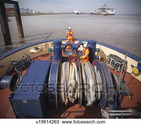Tugboat worker standing on deck View Large Photo Image Stock Image - Tugboat worker standing on deck. Fotosearch