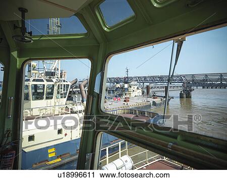 Tugboats in urban harbor View Large Photo Image Stock Image - Tugboats in urban harbor. Fotosearch