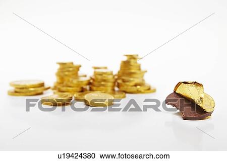 Stock Image - Unwrapped chocolate gold coin. Fotosearch