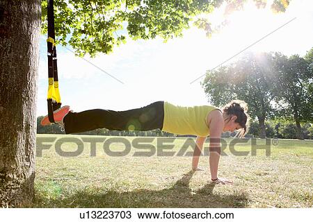 Woman doing push ups in field View Large Photo Image Stock Image - Woman doing push ups in field. Fotosearch