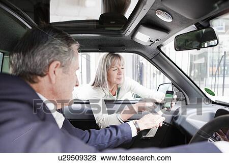 Woman giving directions on cell phone View Large Photo Image Stock Photo - Woman giving directions on cell phone. Fotosearch