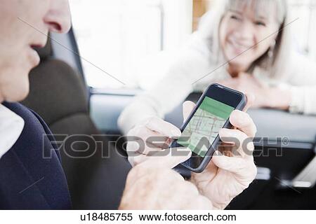 Stock Photography - Woman giving directions on cell phone. Fotosearch