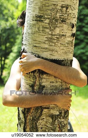 Woman hugging tree in park View Large Photo Image Stock Image - Woman hugging tree in park. Fotosearch