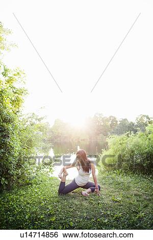 Woman practicing yoga in garden View Large Photo Image Stock Photograph - Woman practicing yoga in garden. Fotosearch