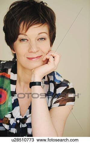 Stock Image - Woman resting chin in hands. Fotosearch
