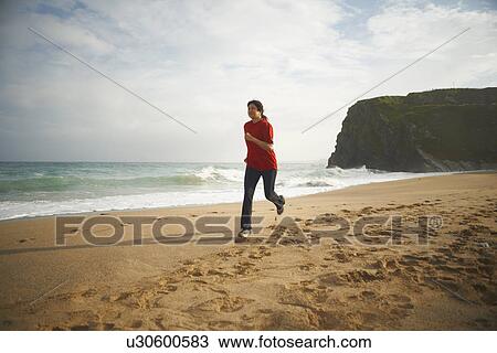 Woman running on beach View Large Photo Image Stock Image - Woman running on beach. Fotosearch