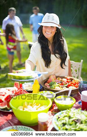 Woman serving food outdoors View Large Photo Image Picture - Woman serving food outdoors. Fotosearch