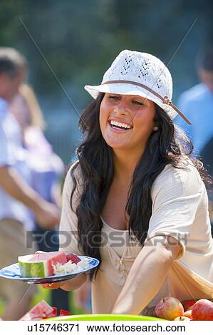 Woman serving herself food outdoors View Large Photo Image Stock Image - Woman serving herself food outdoors. Fotosearch