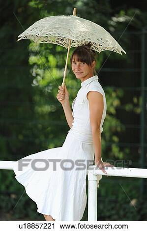 Woman sitting on railing outdoors View Large Photo Image Stock Image - Woman sitting on railing outdoors. Fotosearch