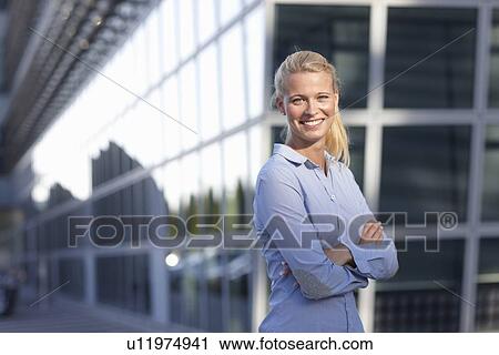Woman standing on city street View Large Photo Image Stock Image - Woman standing on city street. Fotosearch