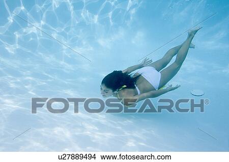 Woman swimming underwater View Large Photo Image Picture - Woman swimming underwater. Fotosearch
