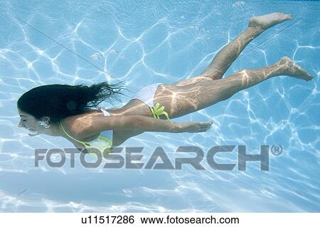 Stock Photograph - Woman swimming underwater. Fotosearch