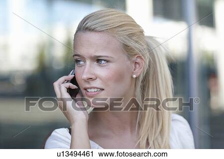 Woman talking on cell phone on street View Large Photo Image Stock Image - Woman talking on cell phone on street. Fotosearch