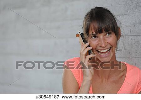 Woman talking on cell phone outdoors View Large Photo Image Stock Photo - Woman talking on cell phone outdoors. Fotosearch