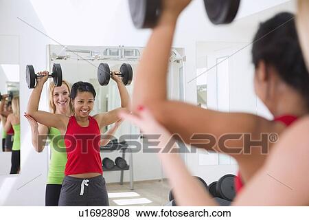 Woman working with trainer in gym View Large Photo Image Stock Photo - Woman working with trainer in gym. Fotosearch