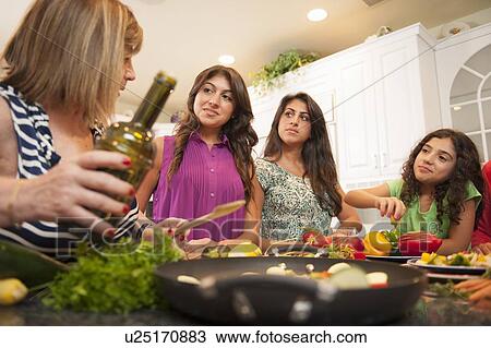 Women cooking together in kitchen View Large Photo Image Stock Image - Women cooking together in kitchen. Fotosearch