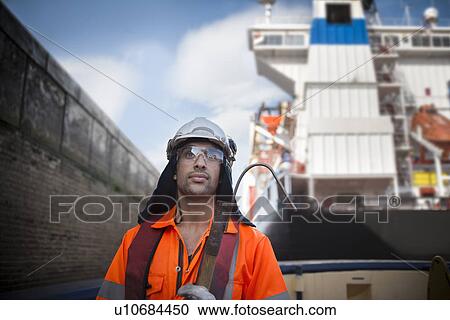 Worker standing on tug boat View Large Photo Image Stock Image - Worker standing on tug boat. Fotosearch