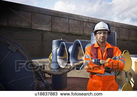 Worker standing on tug boat View Large Photo Image Stock Image - Worker standing on tug boat. Fotosearch