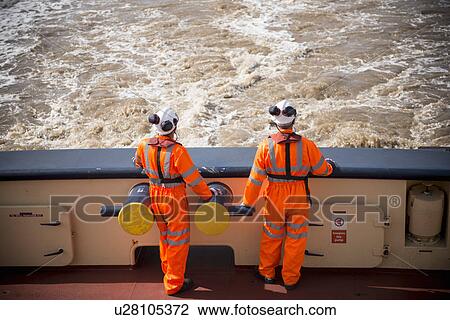 Workers on tug boat overlooking ocean View Large Photo Image Stock Image - Workers on tug boat overlooking ocean. Fotosearch