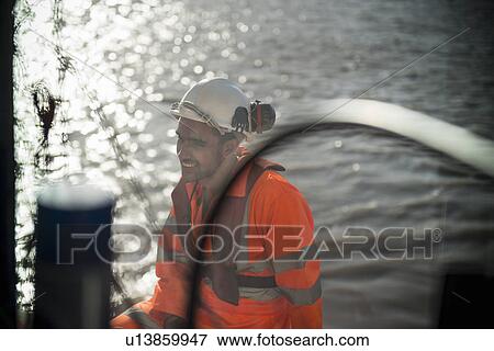 Workers on tug boat sitting on deck View Large Photo Image Stock Photo - Workers on tug boat sitting on deck. Fotosearch