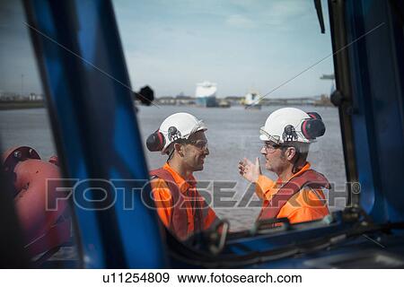 Stock Photo - Workers on tug boat talking. Fotosearch