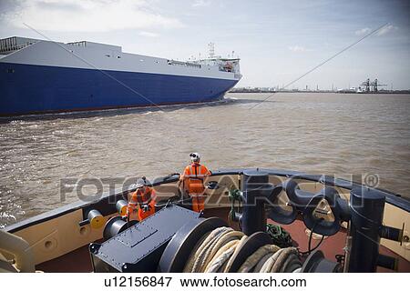 Stock Photo - Workers on tug boat talking. Fotosearch