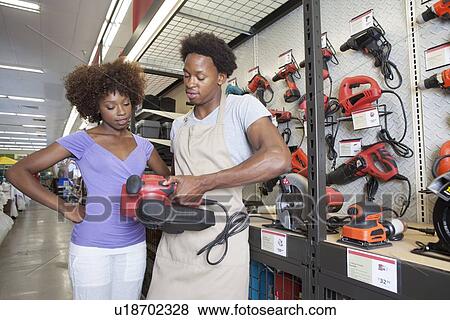 African American woman buying tool at hardware store View Large Photo Image Stock Photo - African American woman buying tool at hardware store. Fotosearch