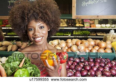 African American woman holding bell peppers and vegetables at supermarket View Large Photo Image Stock Photography - African American woman holding bell peppers and vegetables at supermarket. Fotosearch