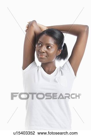 Stock Image - African American young woman with arms raised looking away over white background. Fotosearch