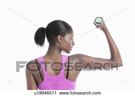 Back view of young woman raising dumbbell over white background View Large Photo Image Stock Image - Back view of young woman raising dumbbell over white background. Fotosearch